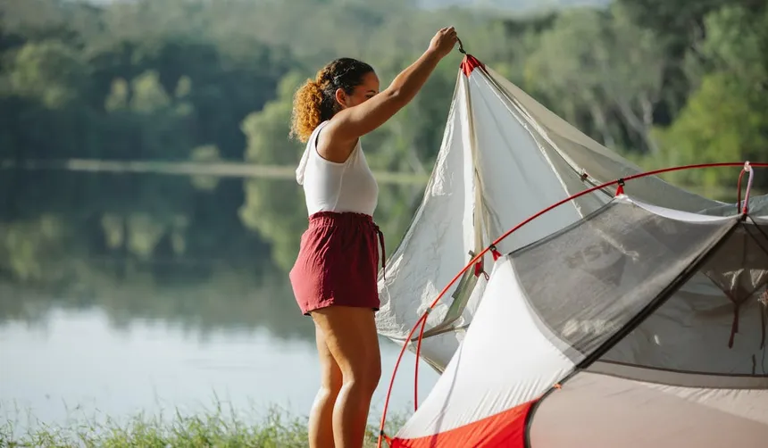 Camping tent setup near a lake representing the outdoor use case for the EcoFlow Delta 3 portable power station